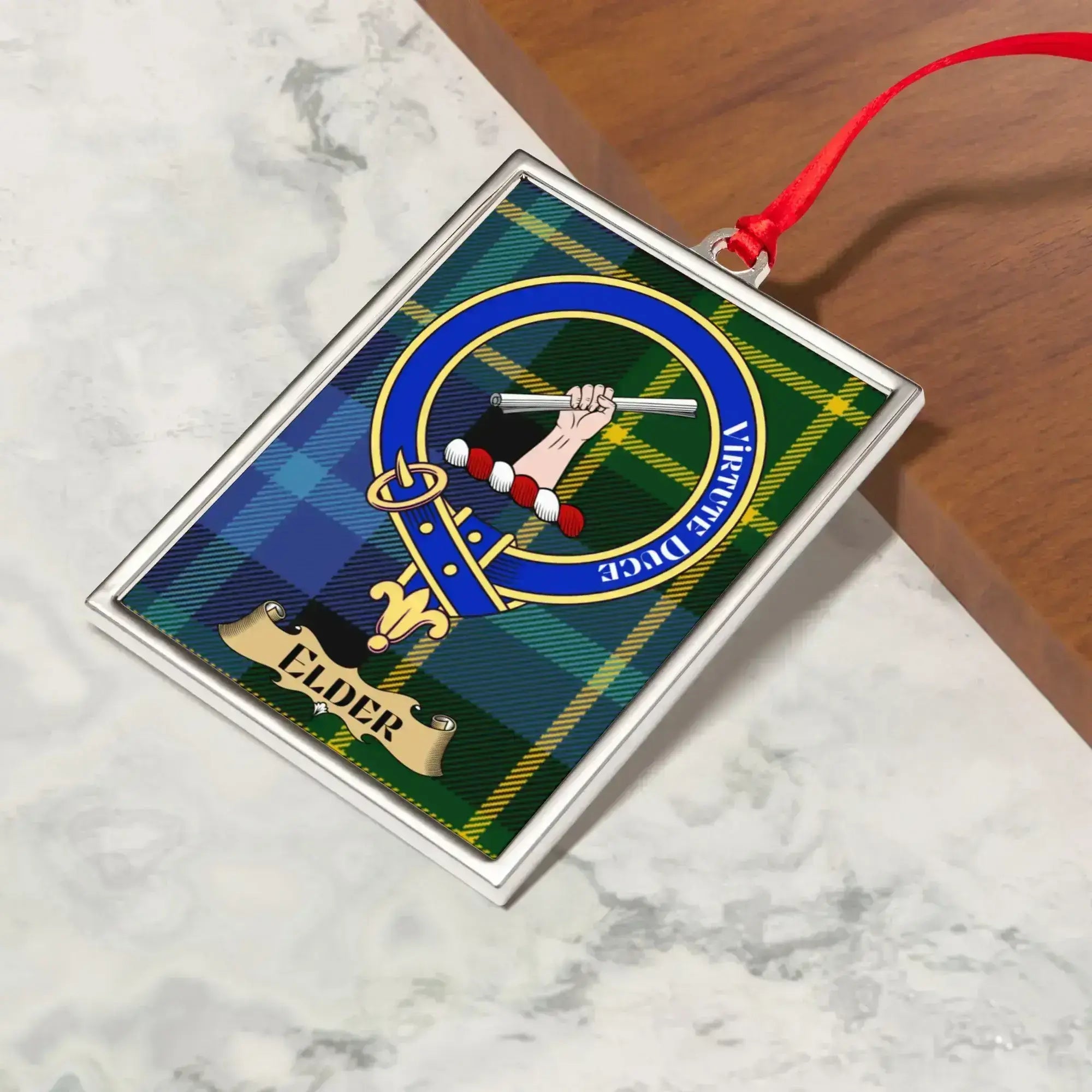 Elder ornament hanging from a Christmas tree branch by its satin ribbon