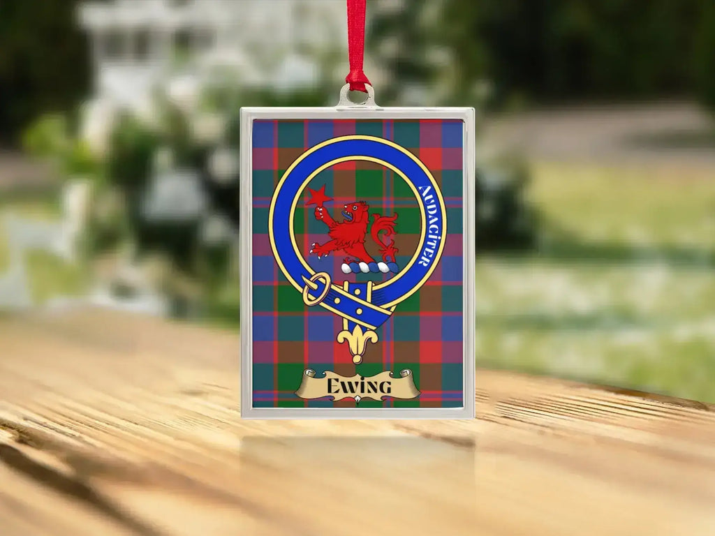 Close-up of the Ewing family crest on a polished silver-frame metal ornament