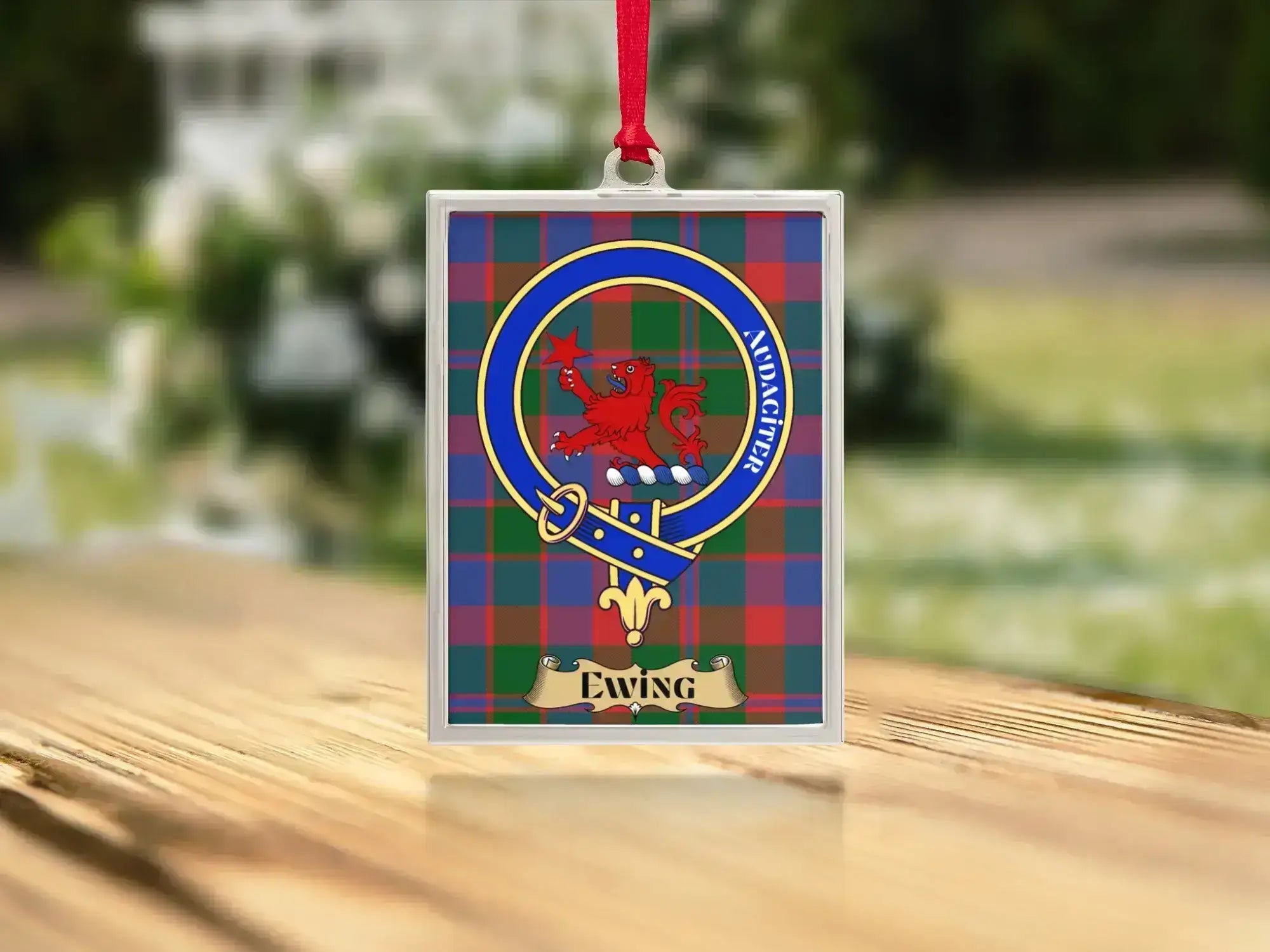 Close-up of the Ewing family crest on a polished silver-frame metal ornament