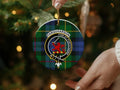 Farquharson clan ornament angled view — 3 inch round ceramic, gold string, crest on tartan background