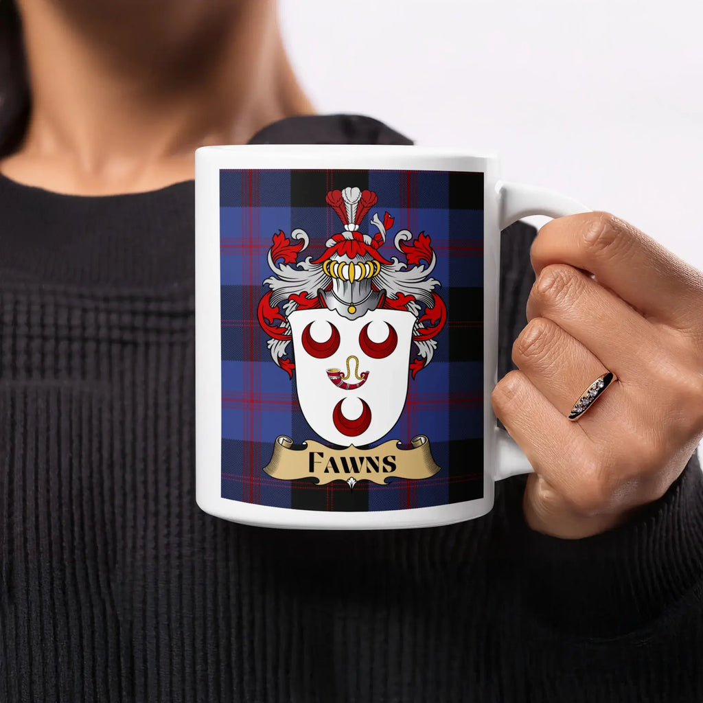 Fawns white ceramic mug held in hand, showing a shield with three red crescents and a hunting horn on blue tartan