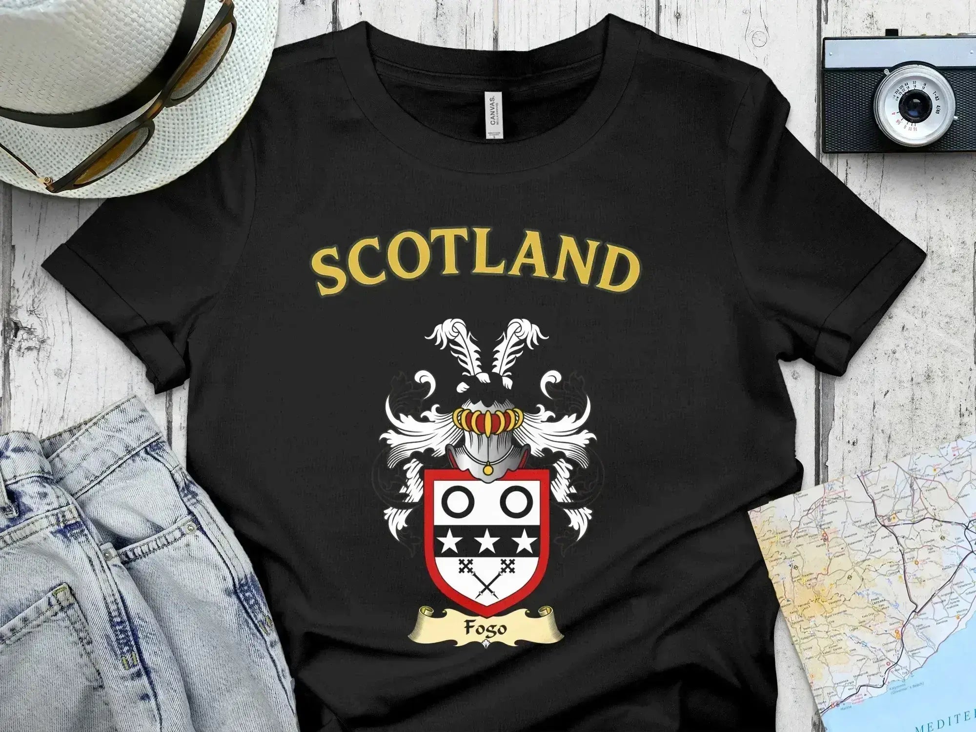 Fogo Scottish clan crest t-shirt — front view of the printed crest on a tartan background