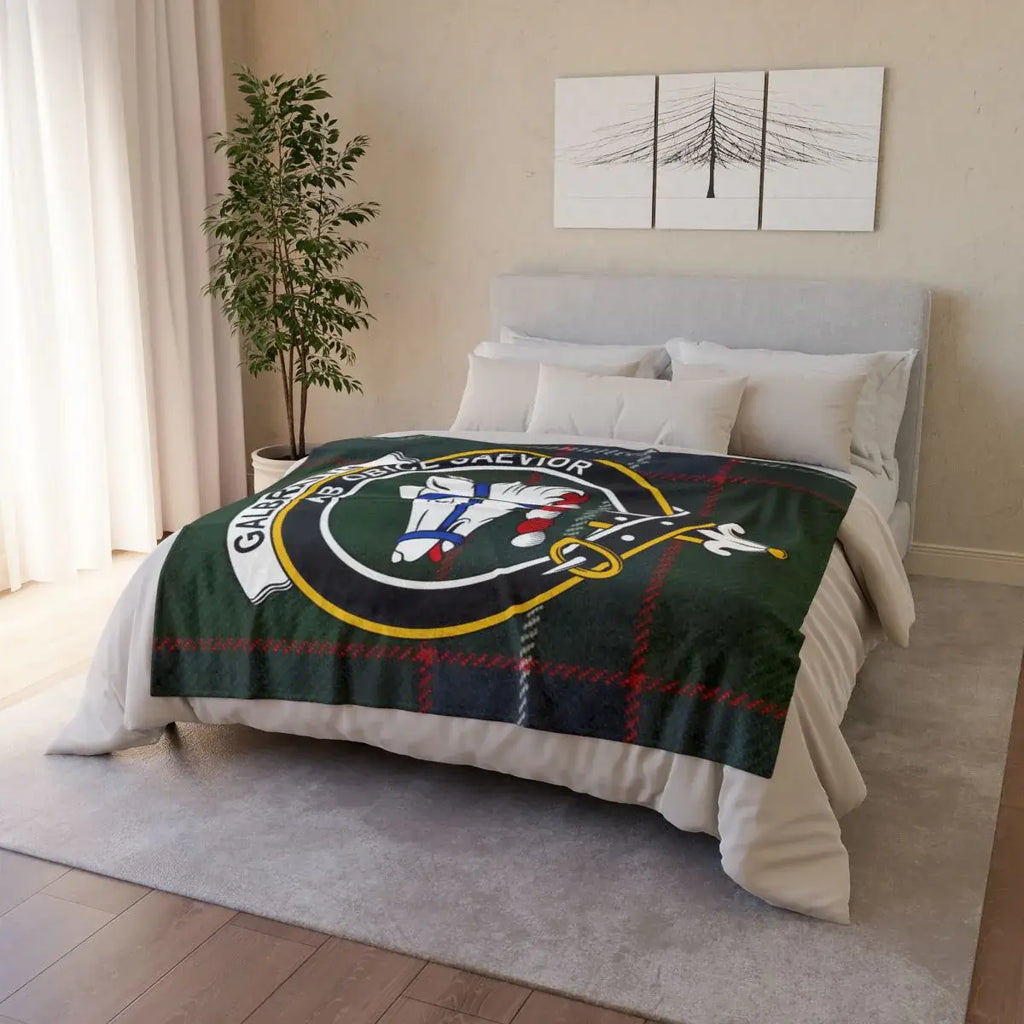 Galbraith clan crest throw blanket — draped over sofa showing printed tartan and crest design