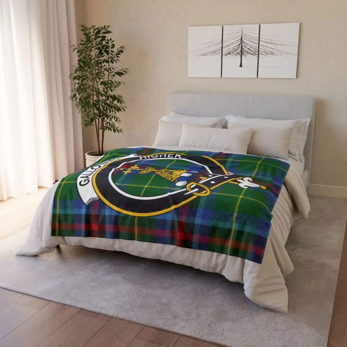 Galloway clan crest throw blanket — draped over sofa showing printed tartan and crest on front