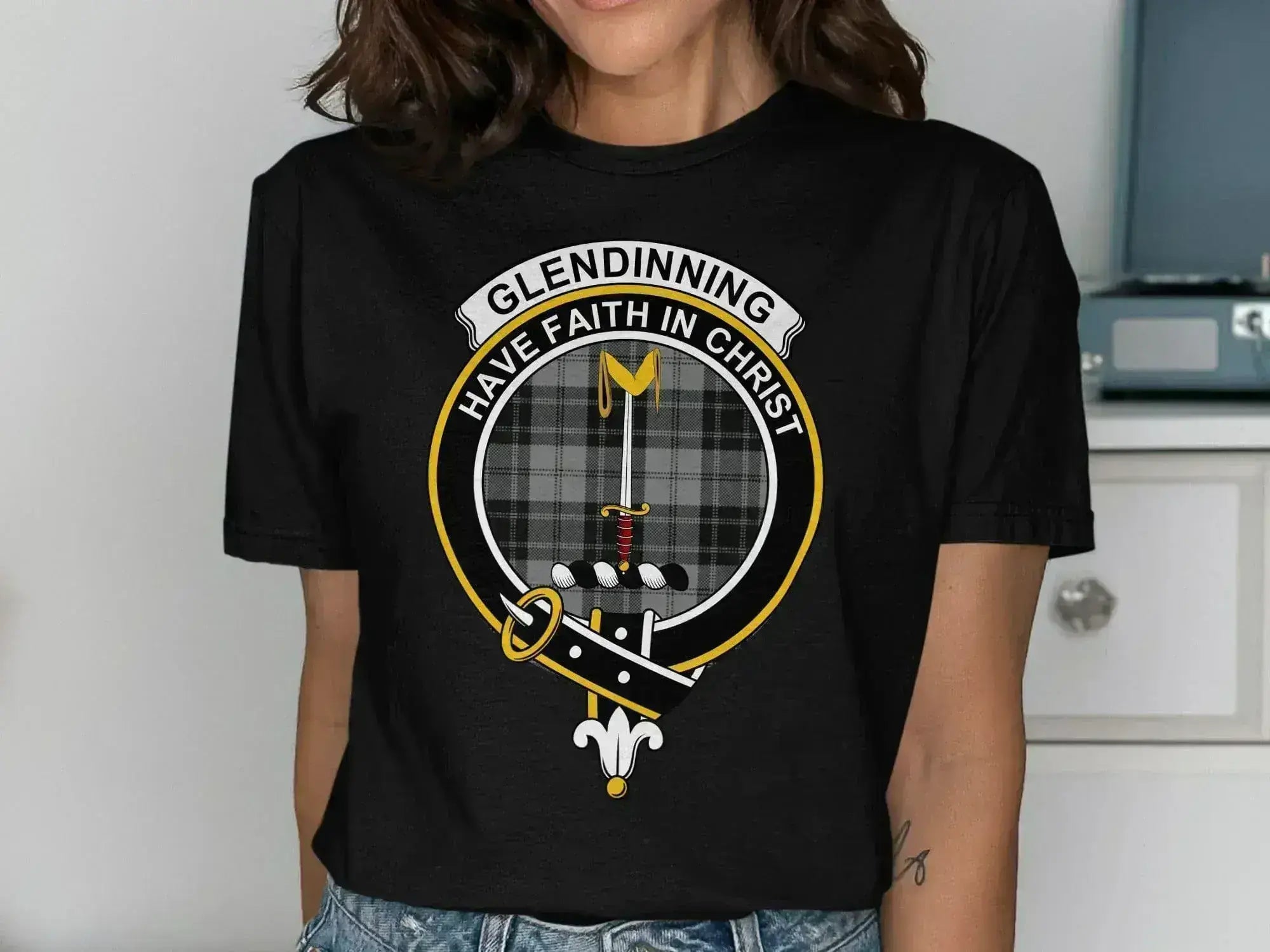 Glendinning clan crest t-shirt in royal blue — close-up of crest and tartan on chest