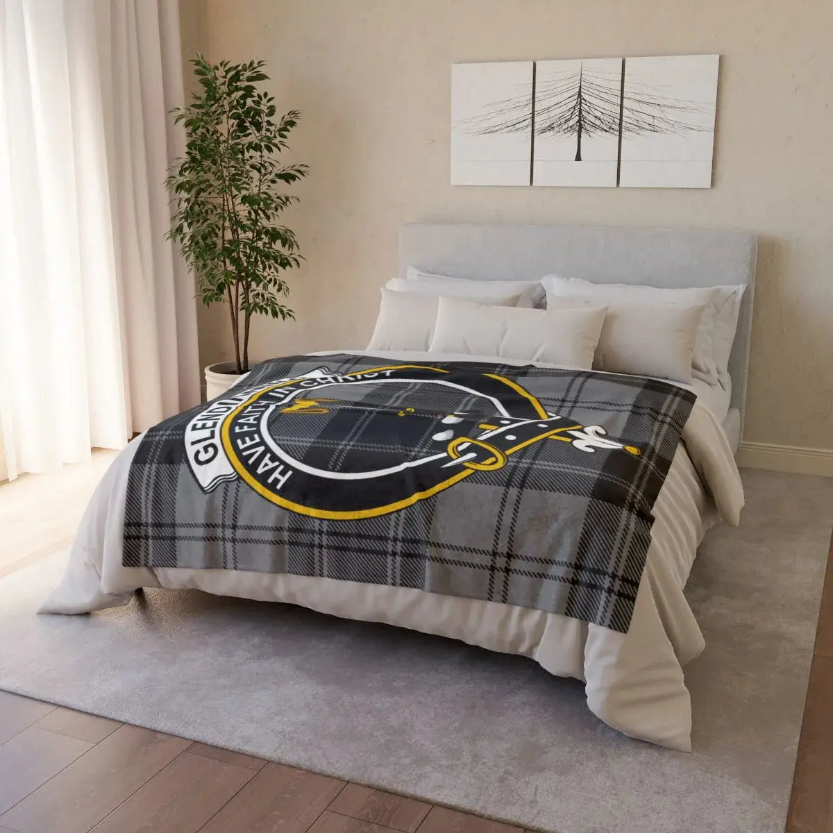 Glendinning clan crest throw blanket — draped over sofa showing printed tartan and crest design