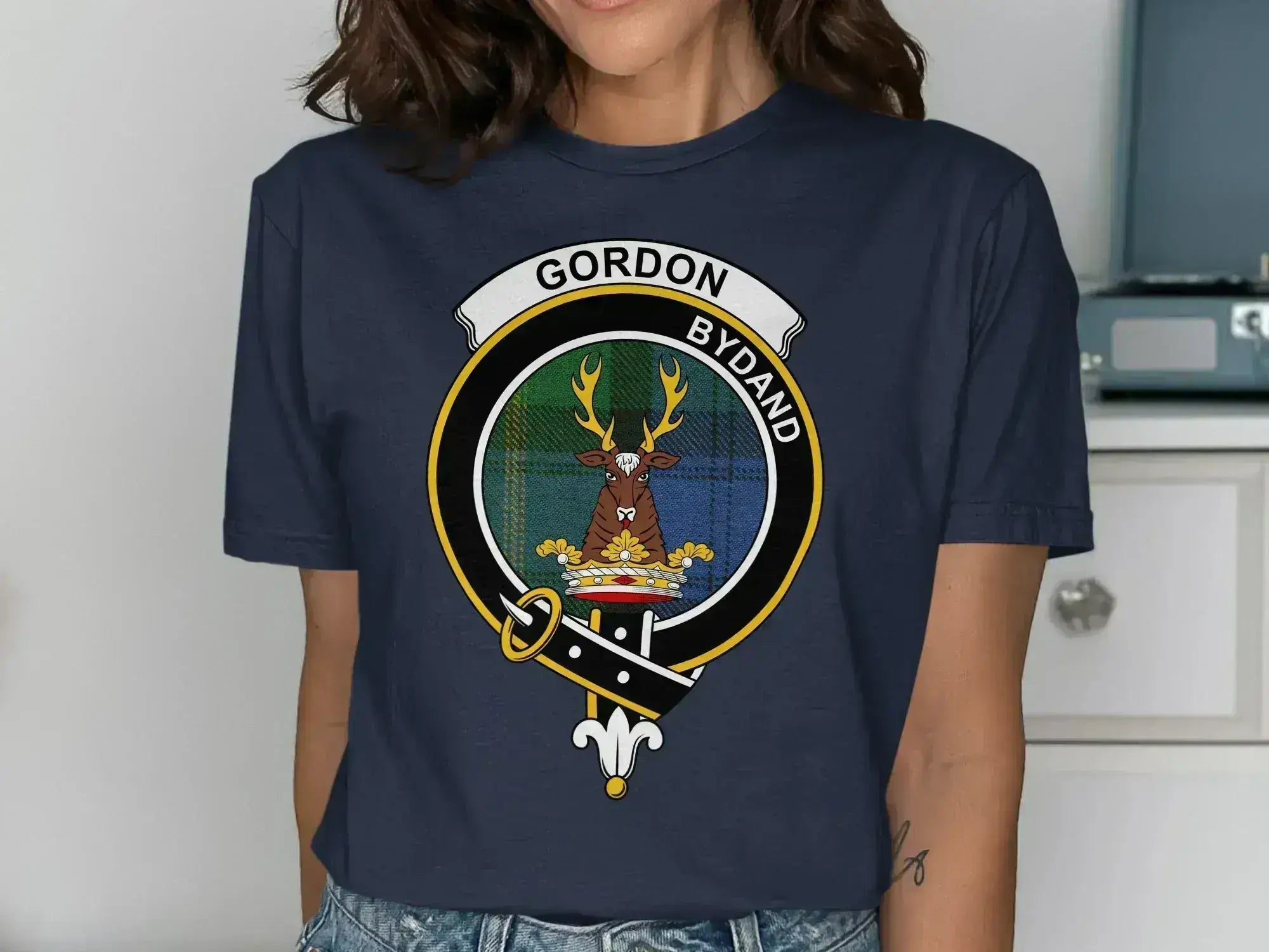 Gordon tartan graphic tee featuring the clan crest and Bydand motto on a dark background