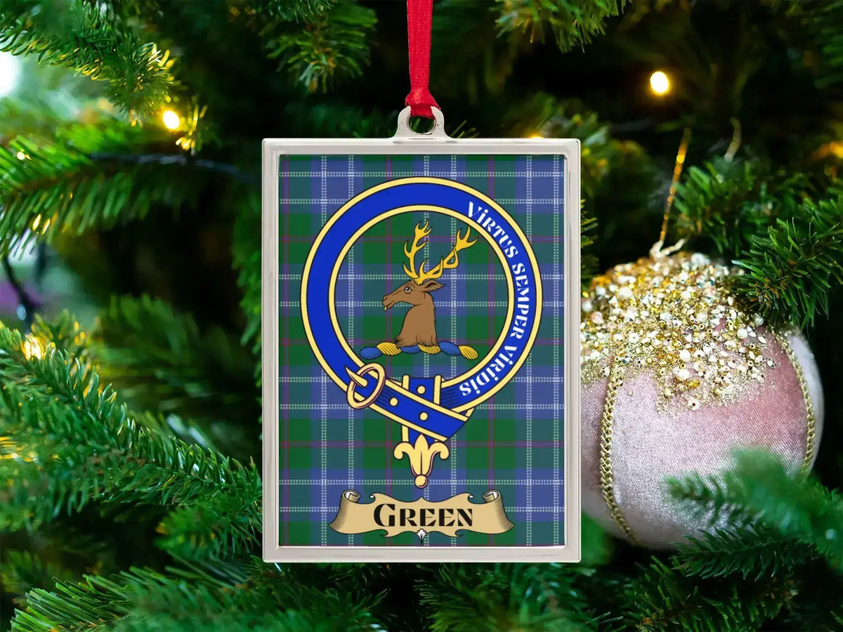 Green clan crest Christmas ornament in a silver frame on a tartan background