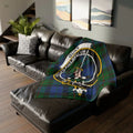 Gunn clan crest tartan throw blanket on sofa — 50x60 polyester, Aut Pax Aut Bellum heraldic design