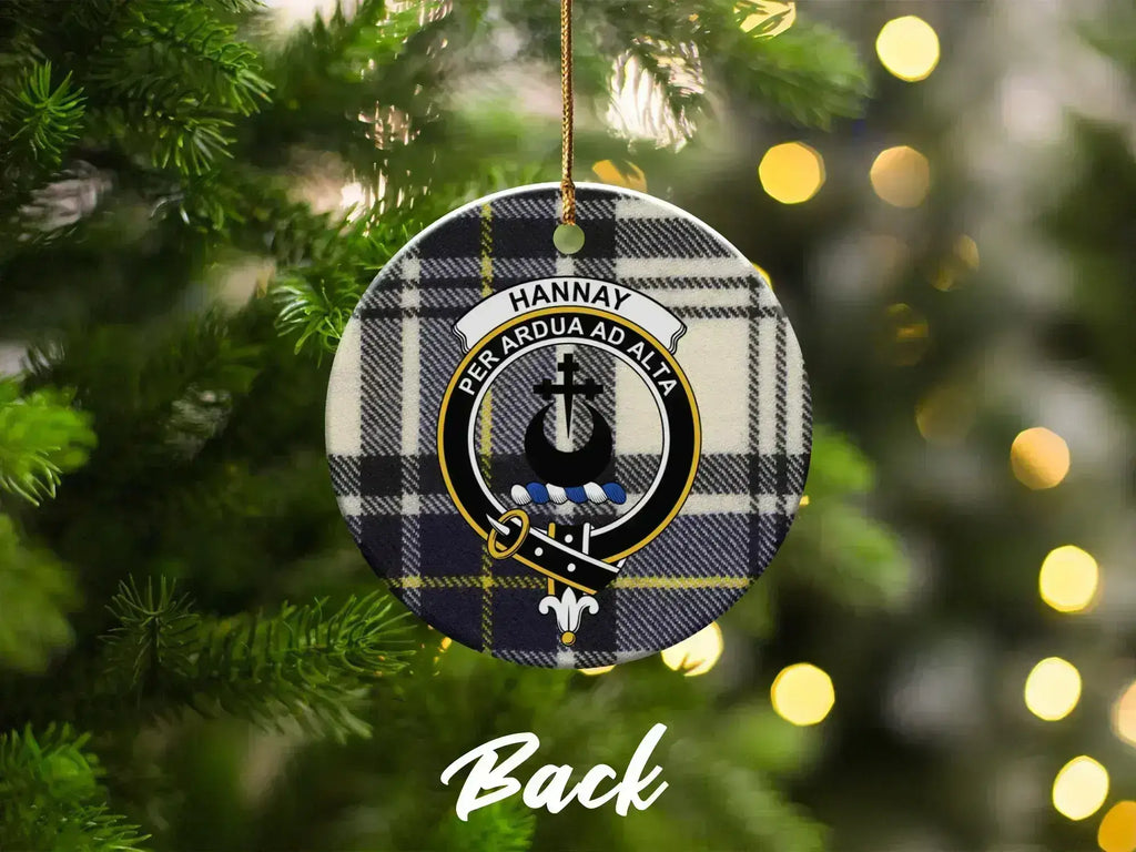 Hannay clan crest ornament hanging on tree — front view showing tartan and Per Ardua Ad Alta motto
