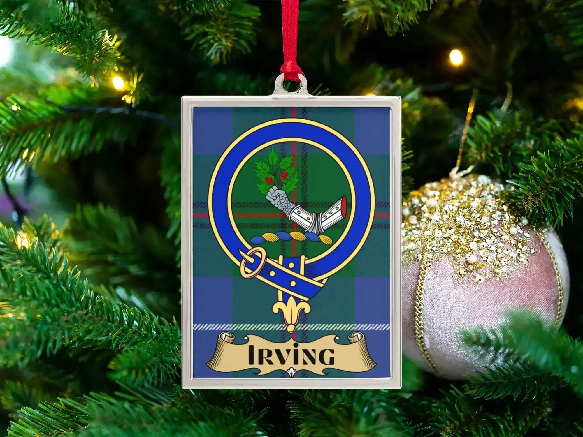 Irving clan crest Christmas ornament in a silver frame on a tartan background