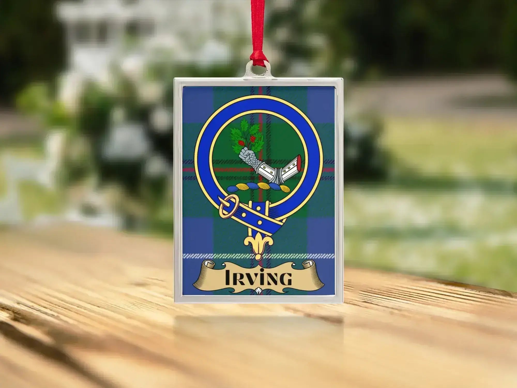 Close-up of the Irving family crest on a polished silver-frame metal ornament
