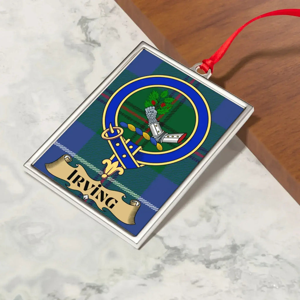 Irving ornament hanging from a Christmas tree branch by its satin ribbon