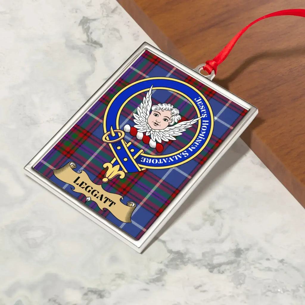 Leggatt ornament hanging from a Christmas tree branch by its satin ribbon