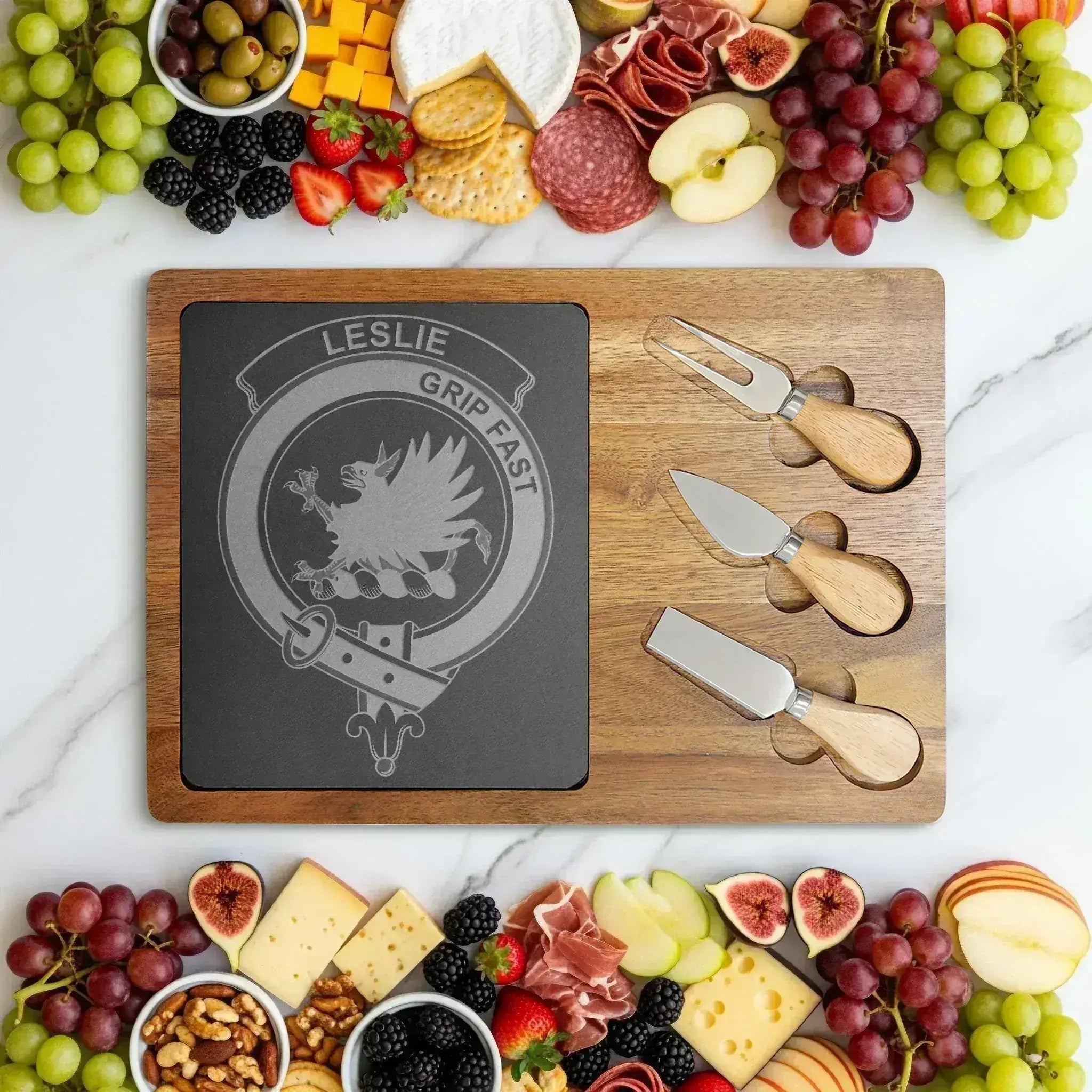Leslie clan crest engraved charcuterie board — acacia wood and slate with Grip Fast griffin design and cutlery