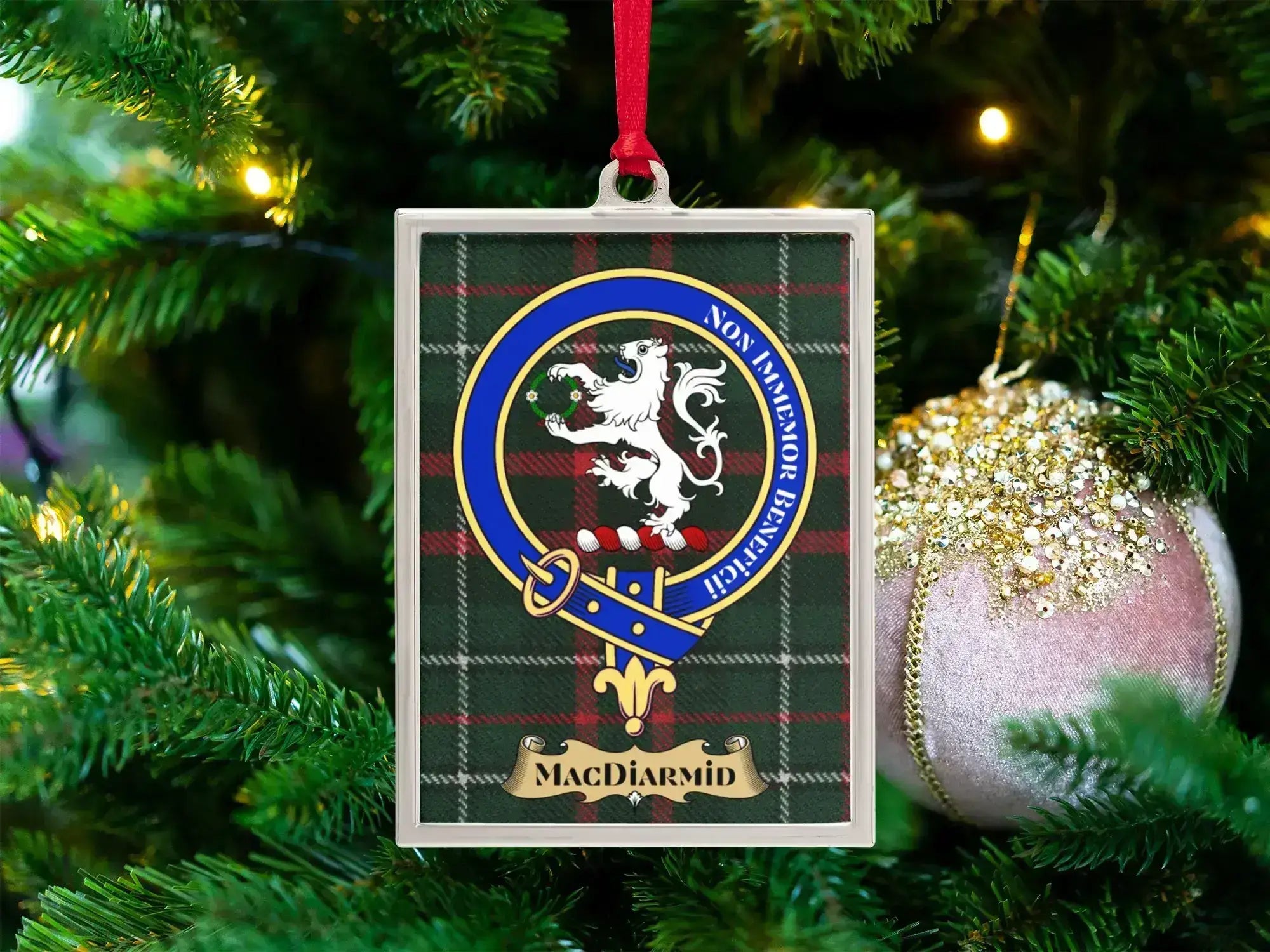 MacDiarmid clan crest Christmas ornament in a silver frame on a tartan background