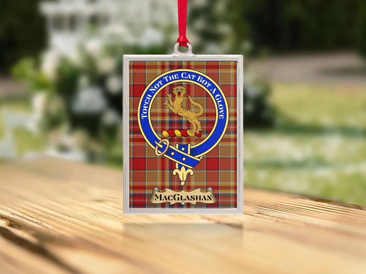 Close-up of the MacGlashan family crest on a polished silver-frame metal ornament