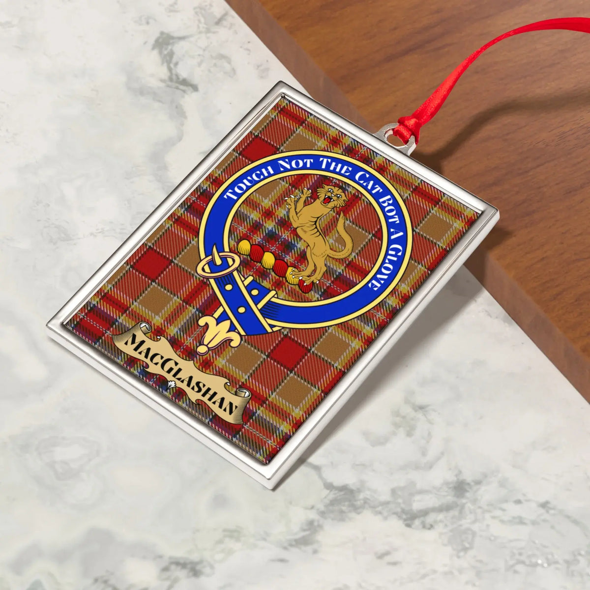 MacGlashan ornament hanging from a Christmas tree branch by its satin ribbon