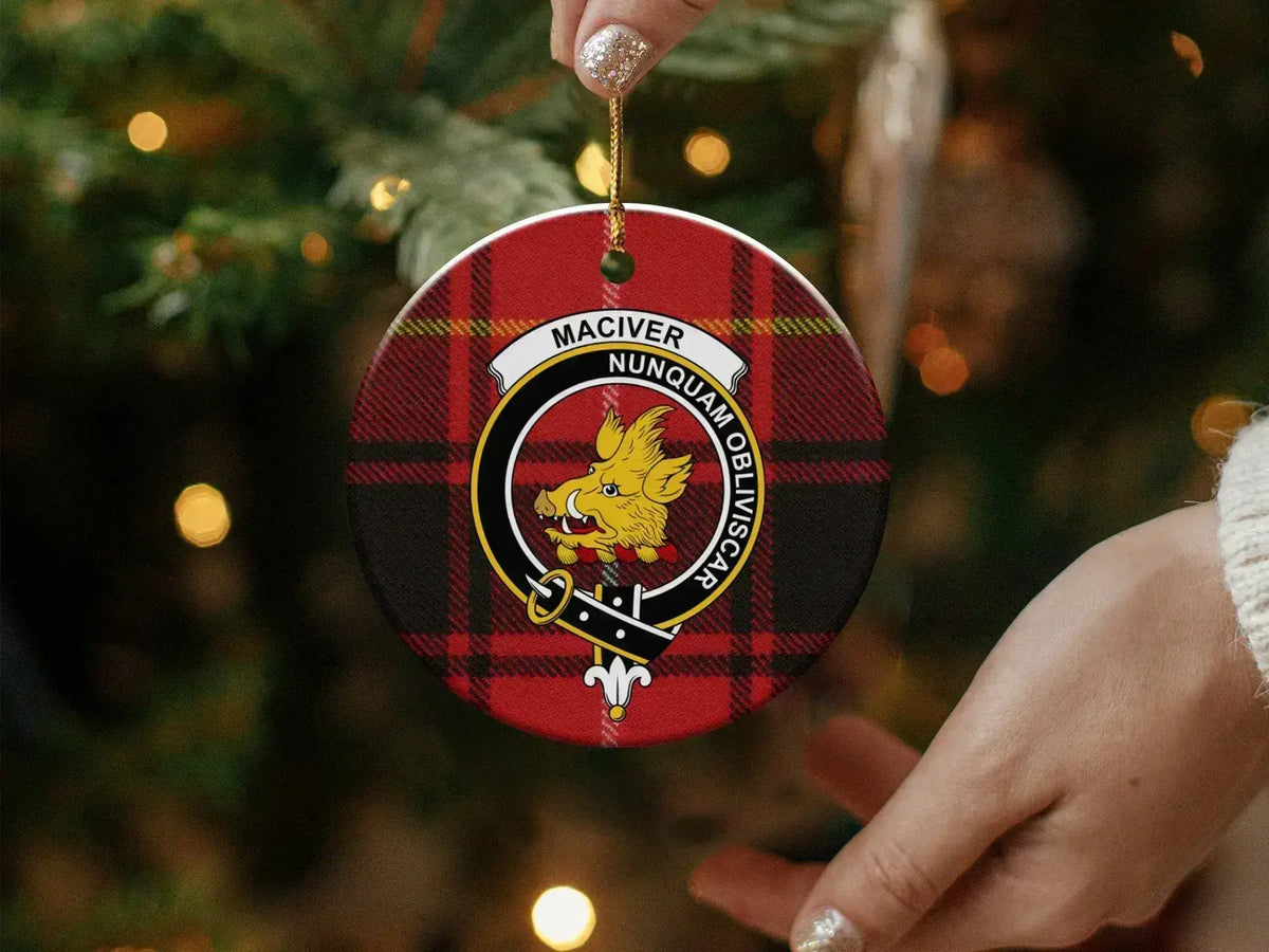 MacIver Nunquam Obliviscar round ornament in hand — shows scale and double-sided print detail