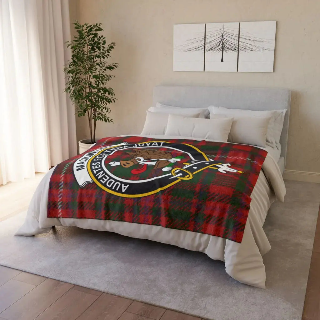 MacKinnon tartan crest throw draped over sofa — lightweight Scottish clan blanket in use