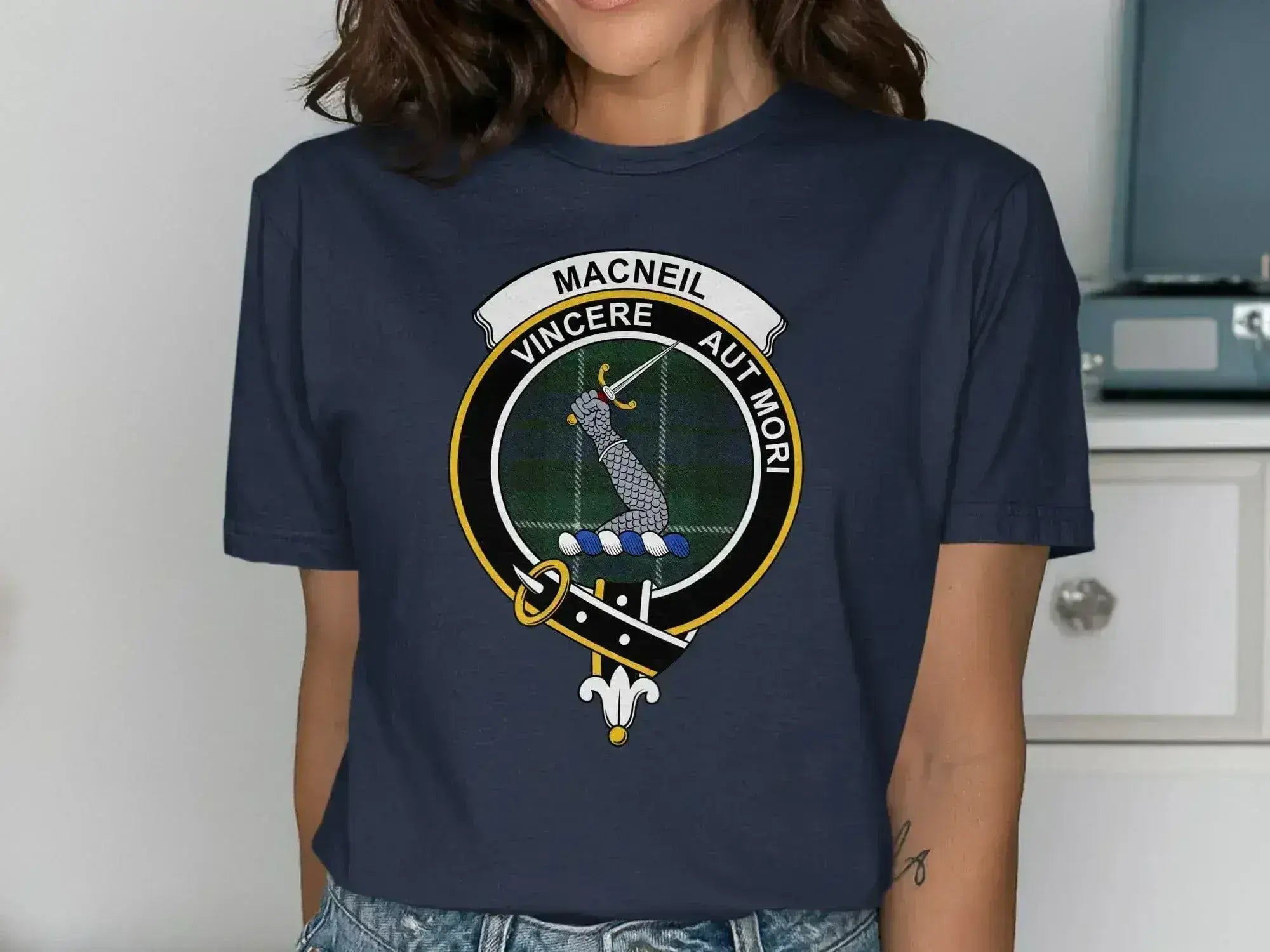 MacNeil clan crest t-shirt in black — front view showing Vincere Aut Mori tartan badge print