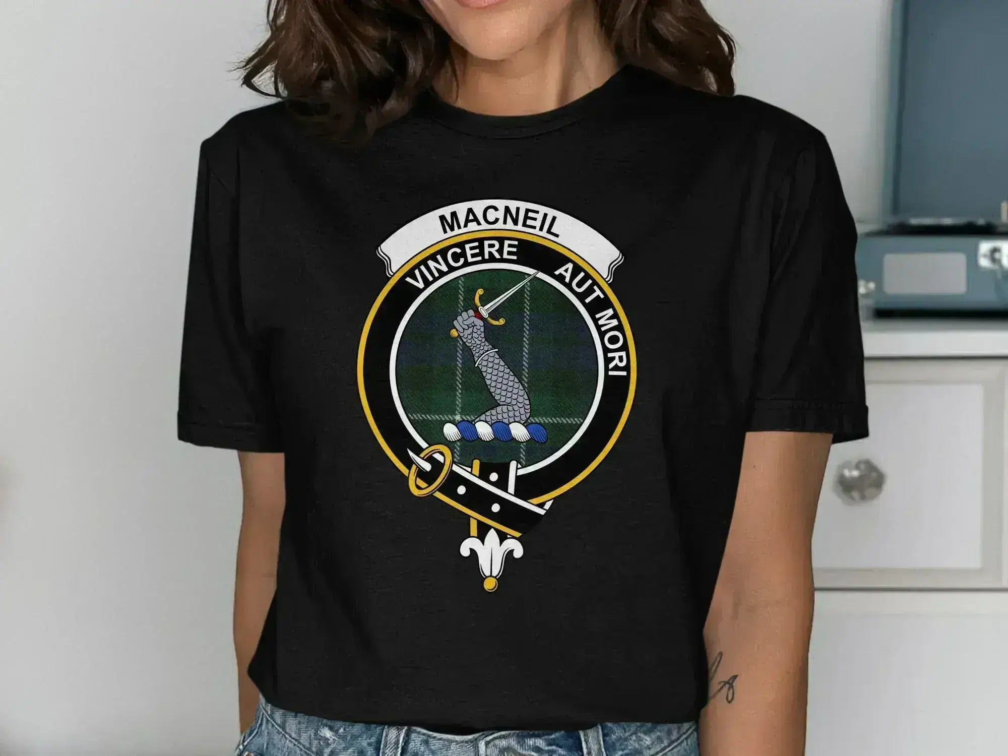 Clan MacNeil t-shirt in forest green — crest and tartan graphic on relaxed unisex cotton tee