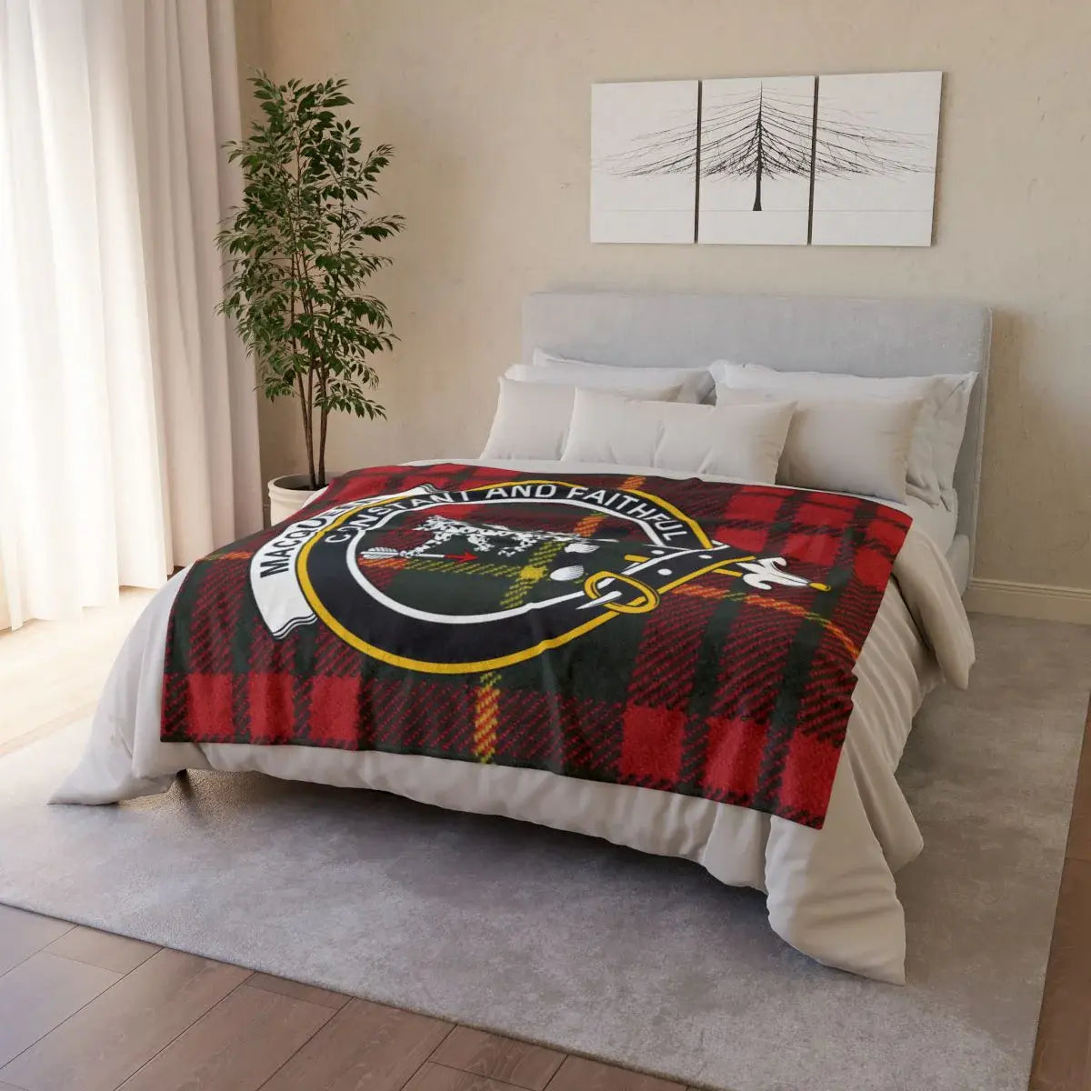 MacQueen clan crest throw draped on bed — Scottish tartan blanket in red and black plaid