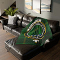 MacArthur clan crest tartan throw blanket — Fide et Opera design on 50x60 inch polyester, draped on a sofa