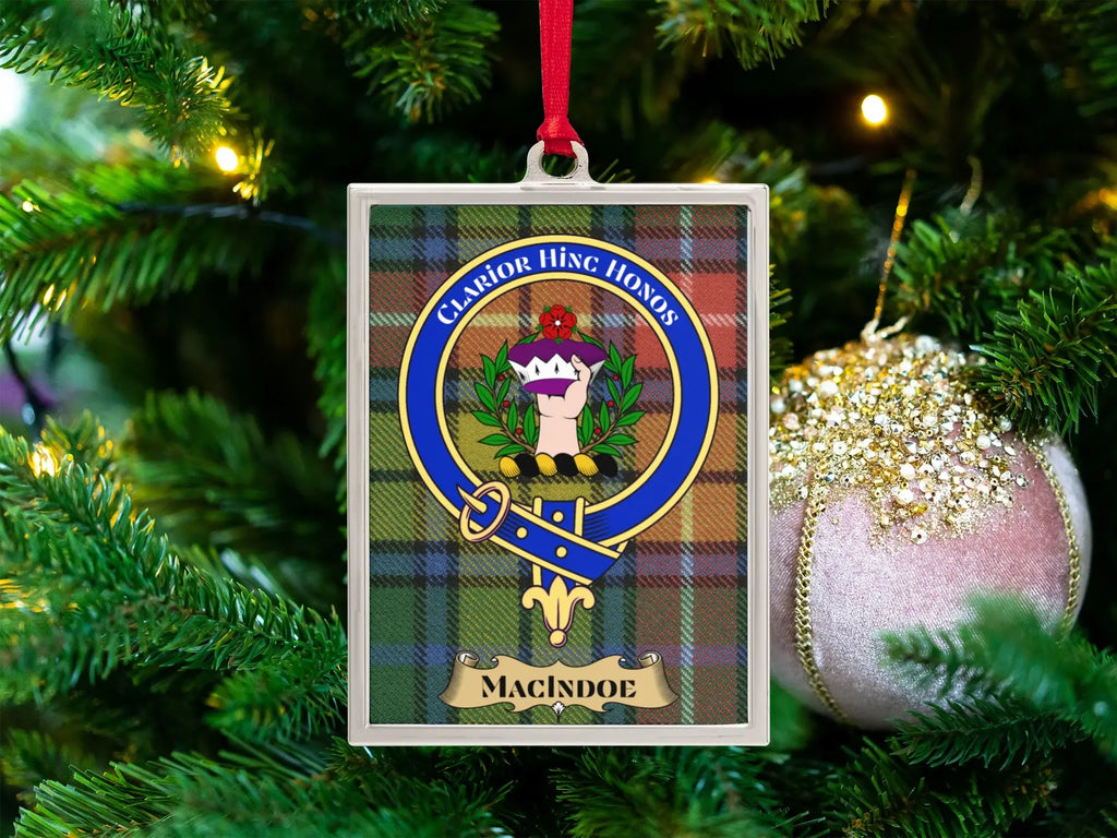 Macindoe clan crest Christmas ornament in a silver frame on a tartan background