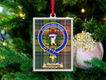 Macindoe clan crest Christmas ornament in a silver frame on a tartan background