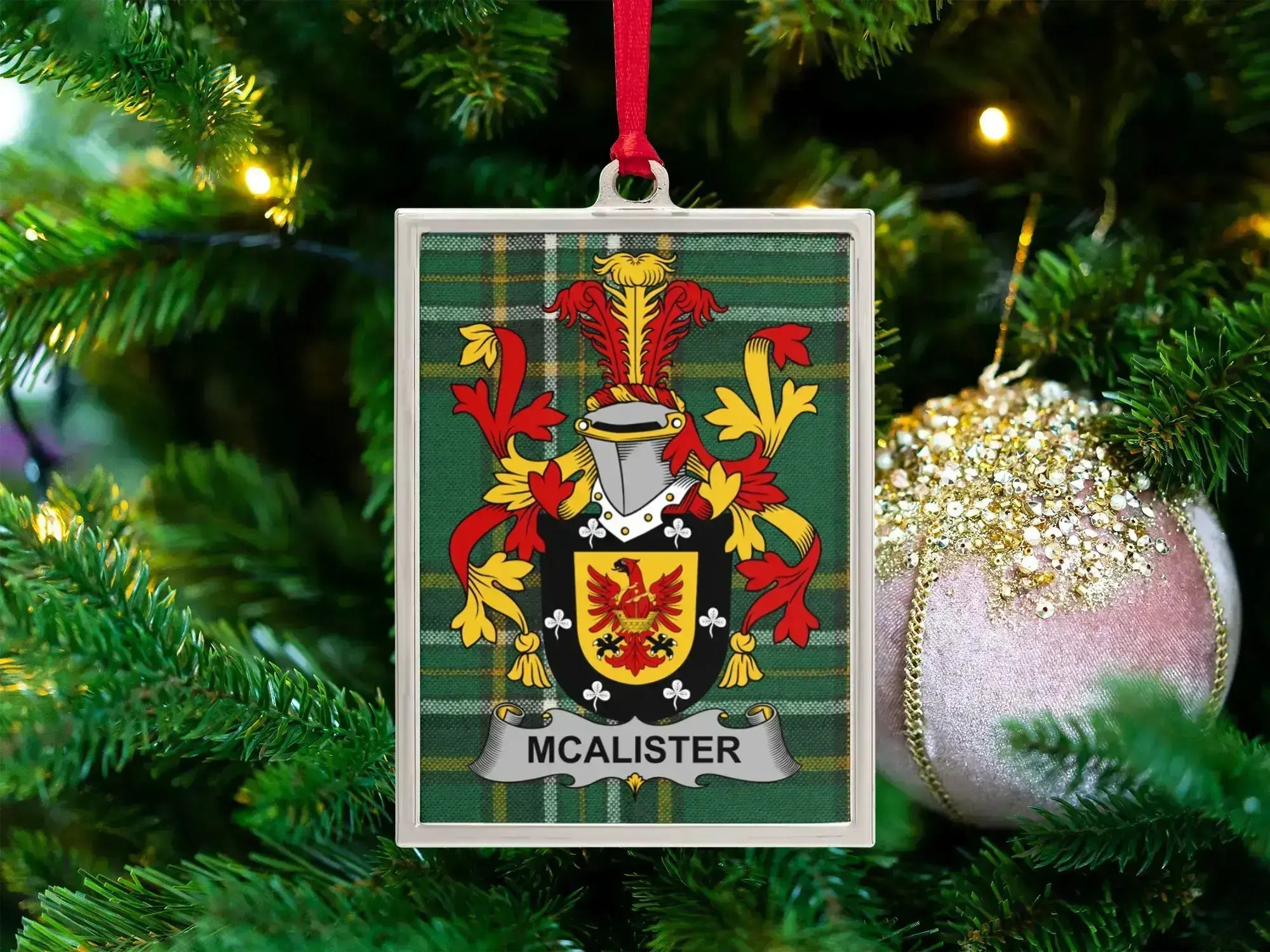 McAlister Irish family crest Christmas ornament — crest on the Irish national tartan in a silver-tone frame