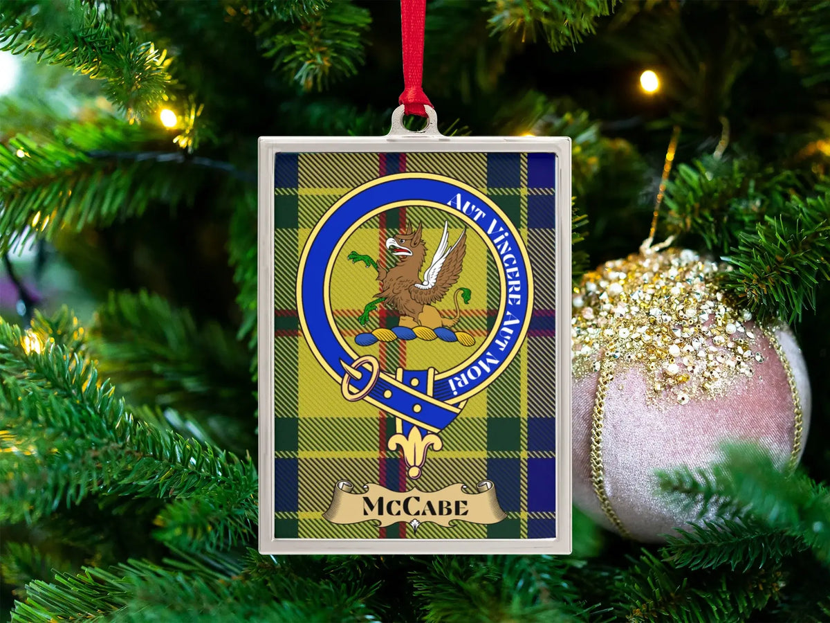 McCabe clan crest Christmas ornament in a silver frame on a tartan background