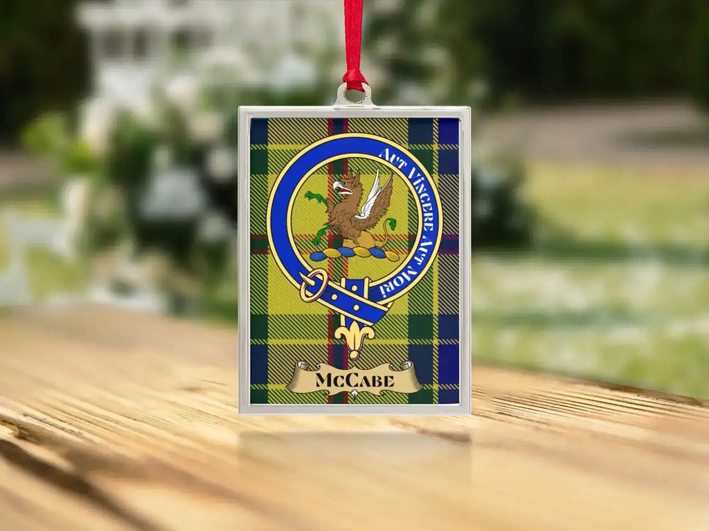 Close-up of the McCabe family crest on a polished silver-frame metal ornament