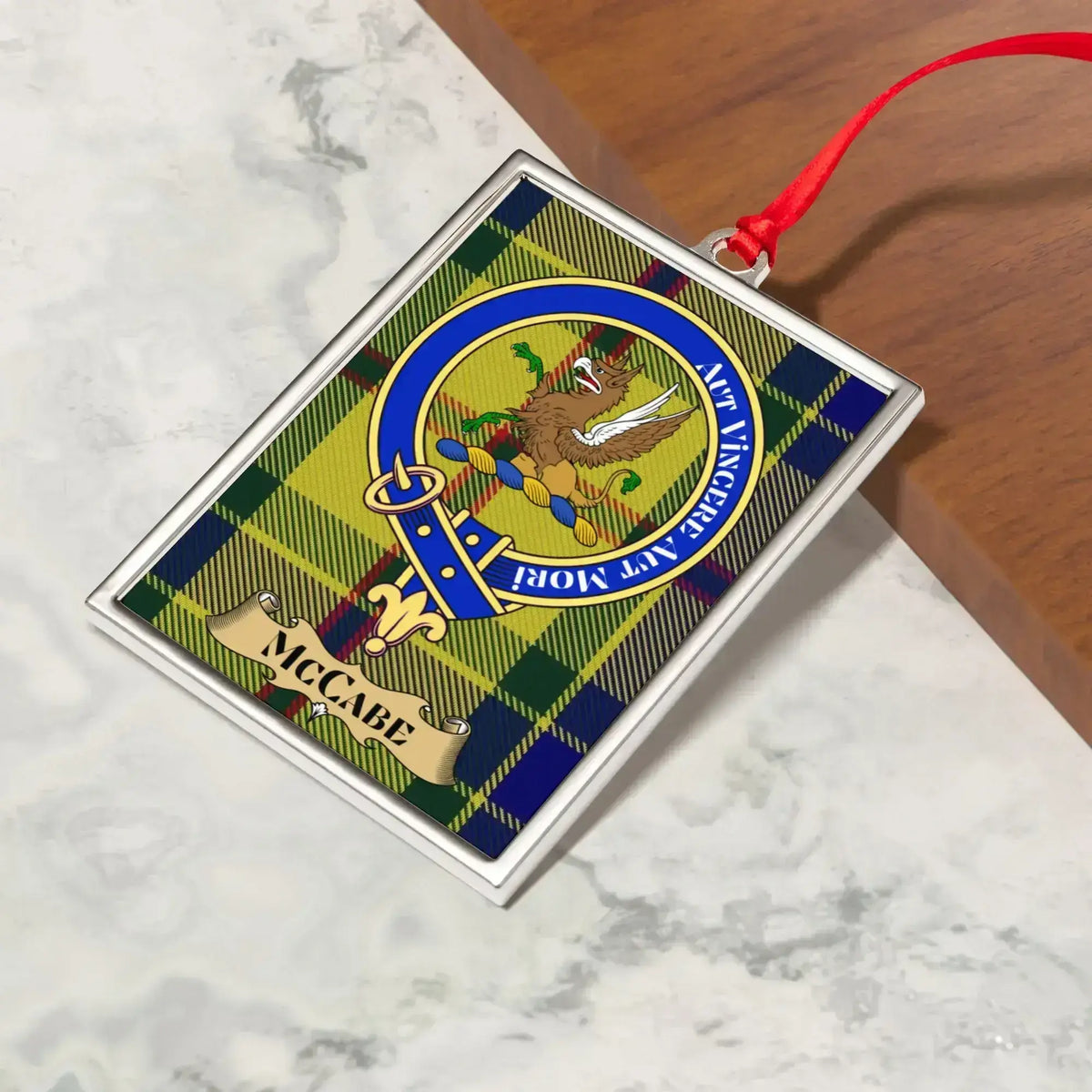 McCabe ornament hanging from a Christmas tree branch by its satin ribbon