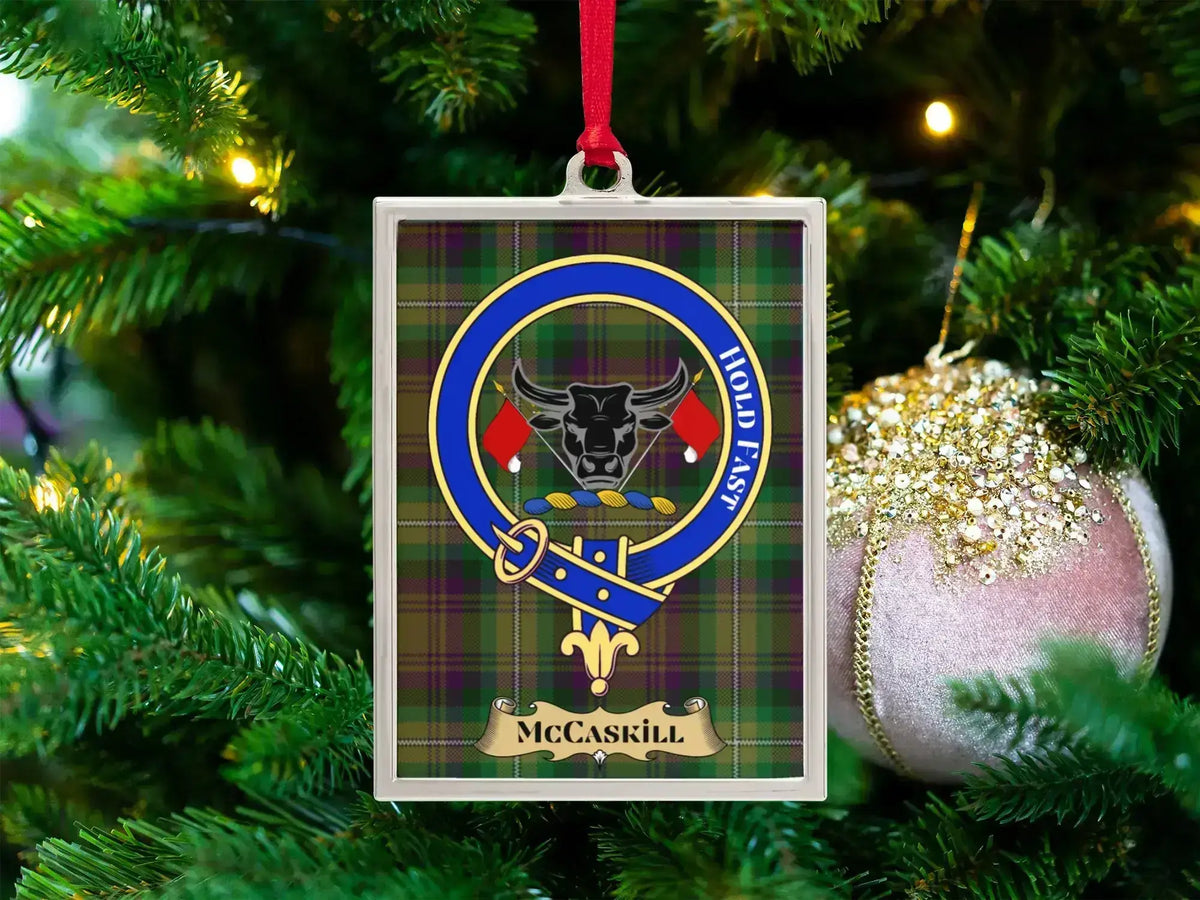 McCaskill clan crest Christmas ornament in a silver frame on a tartan background