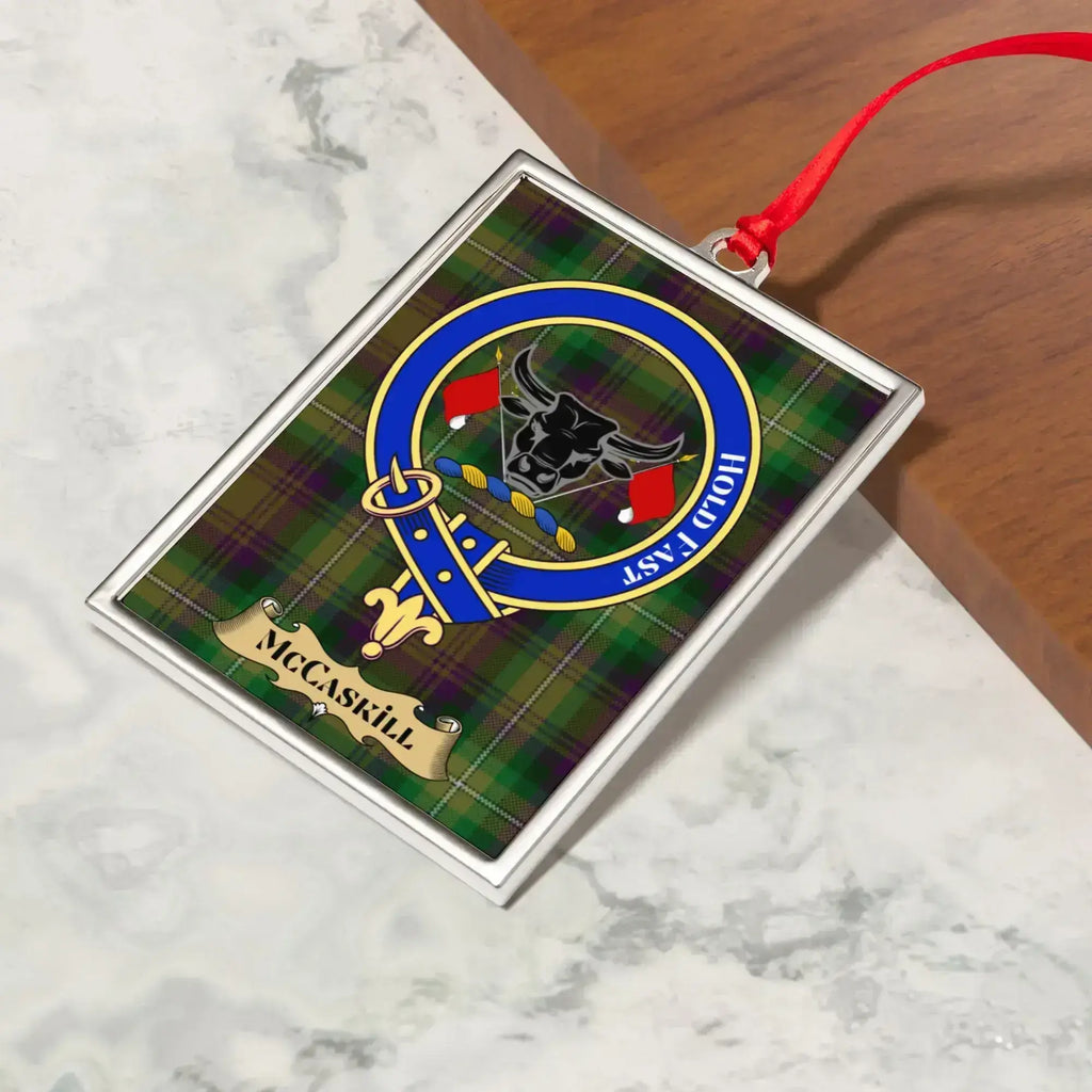 McCaskill ornament hanging from a Christmas tree branch by its satin ribbon