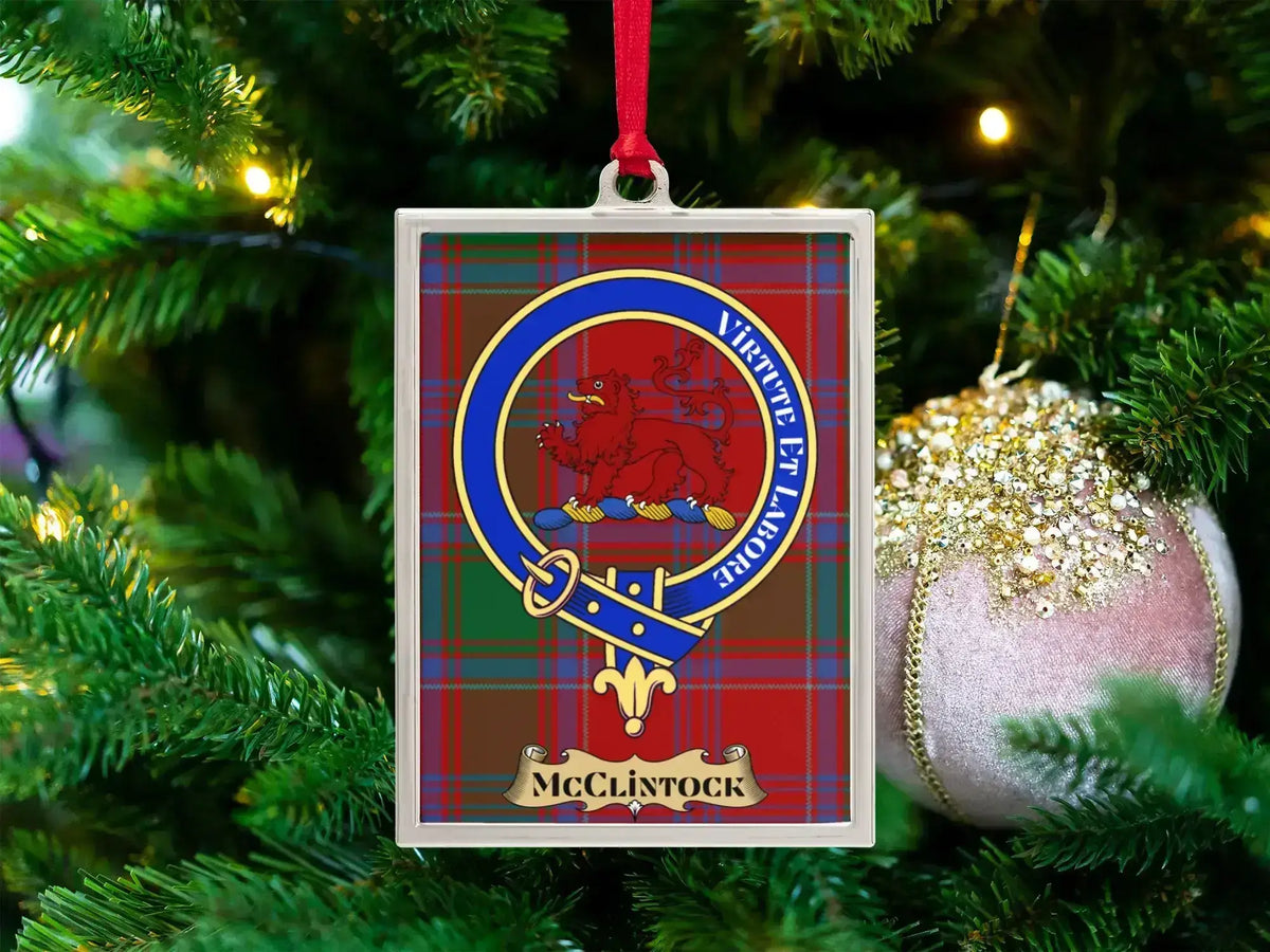 McClintock clan crest Christmas ornament in a silver frame on a tartan background