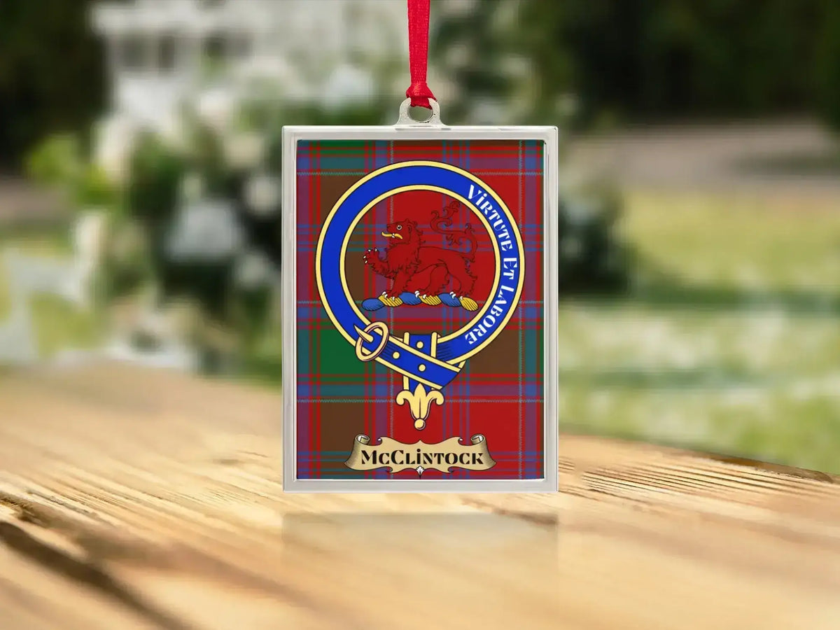 Close-up of the McClintock family crest on a polished silver-frame metal ornament