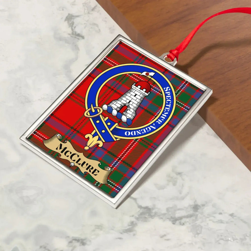 McClure ornament hanging from a Christmas tree branch by its satin ribbon
