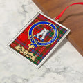 McClure ornament hanging from a Christmas tree branch by its satin ribbon