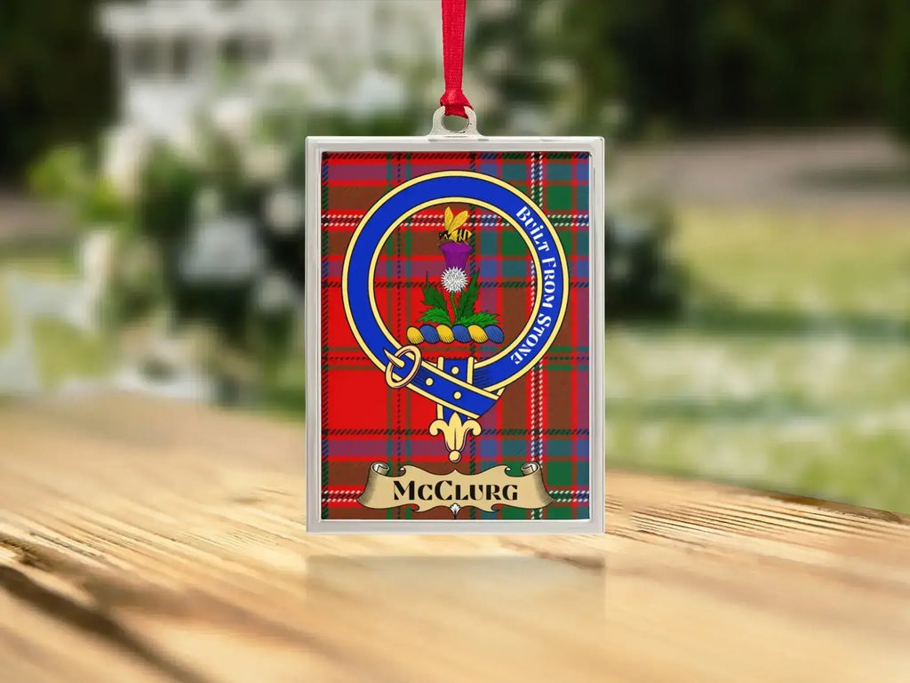 Close-up of the McClurg family crest on a polished silver-frame metal ornament