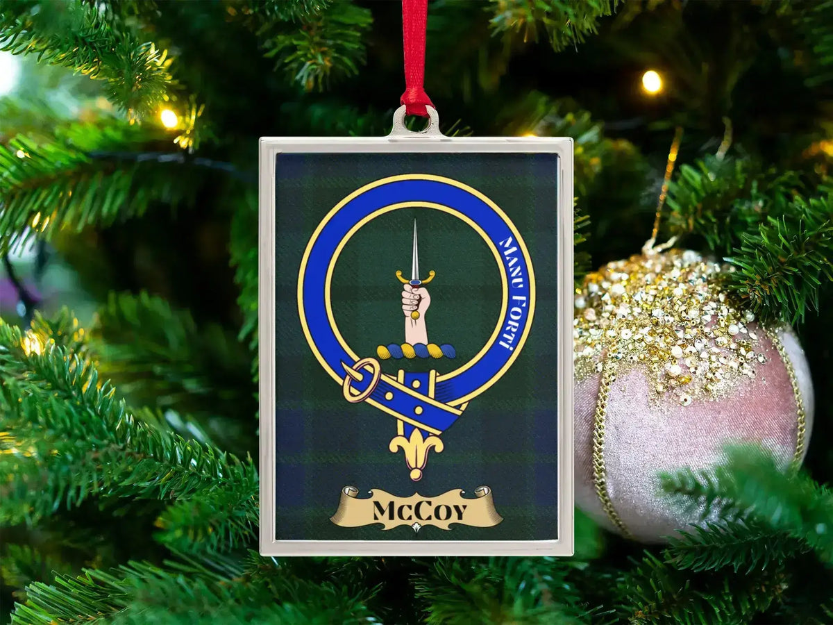 McCoy clan crest Christmas ornament in a silver frame on a tartan background