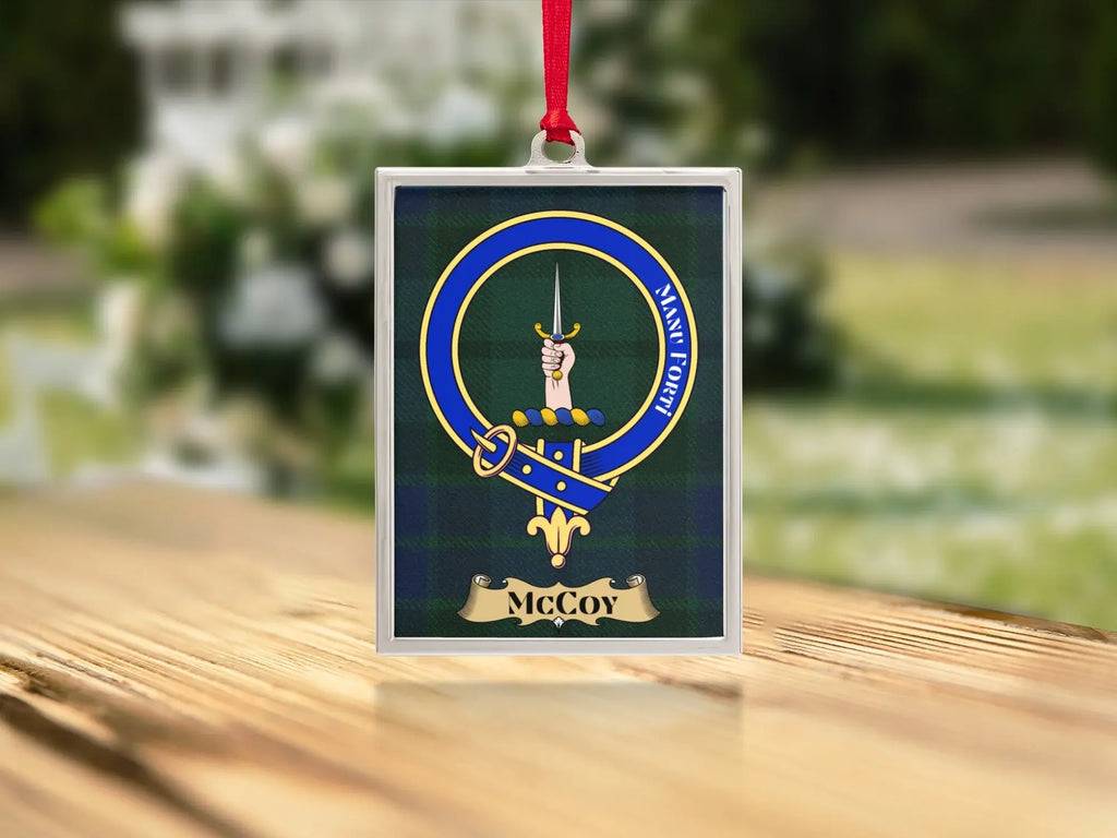 Close-up of the McCoy family crest on a polished silver-frame metal ornament