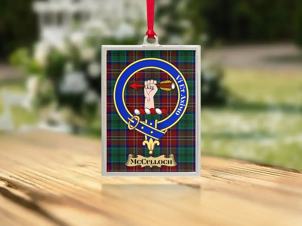 Close-up of the McCulloch family crest on a polished silver-frame metal ornament