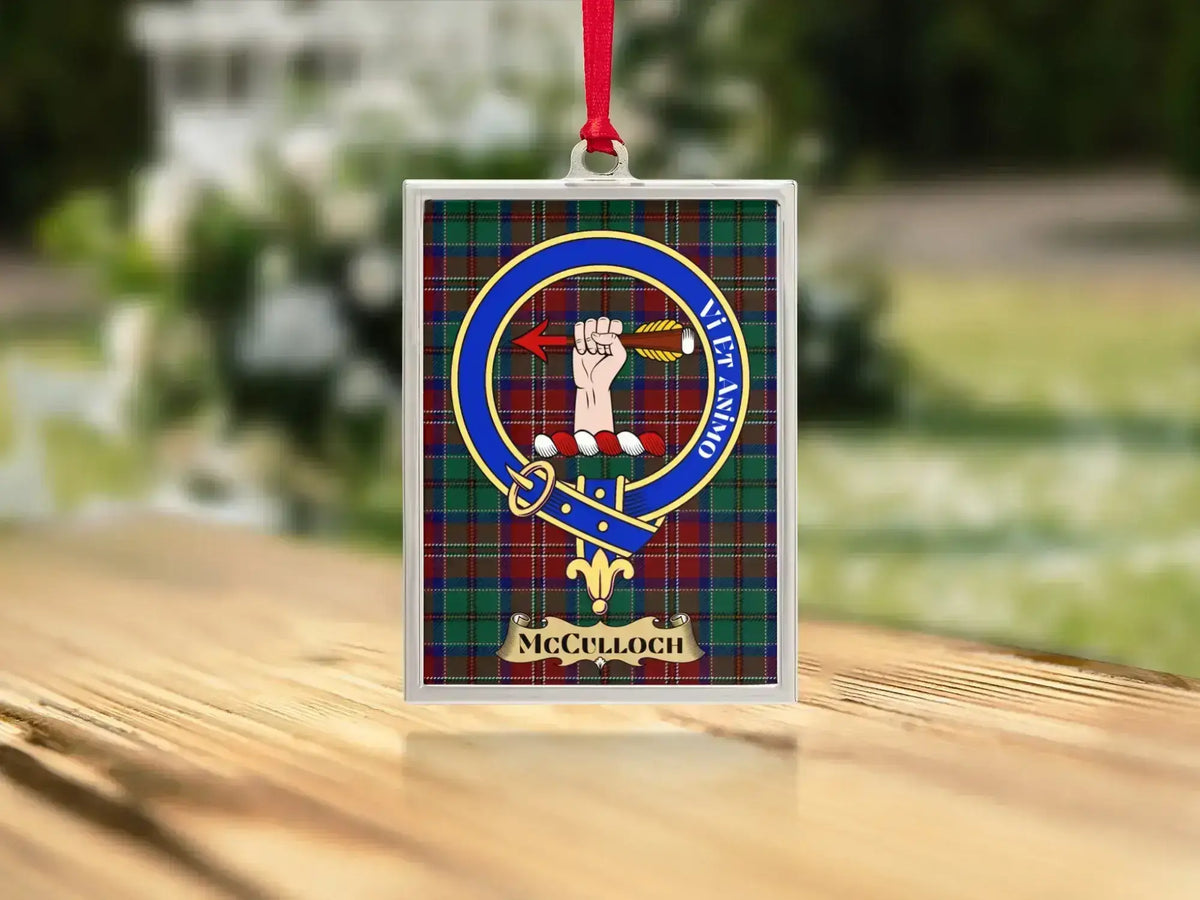 Close-up of the McCulloch family crest on a polished silver-frame metal ornament