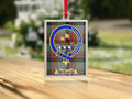 Close-up of the McGavin family crest on a polished silver-frame metal ornament