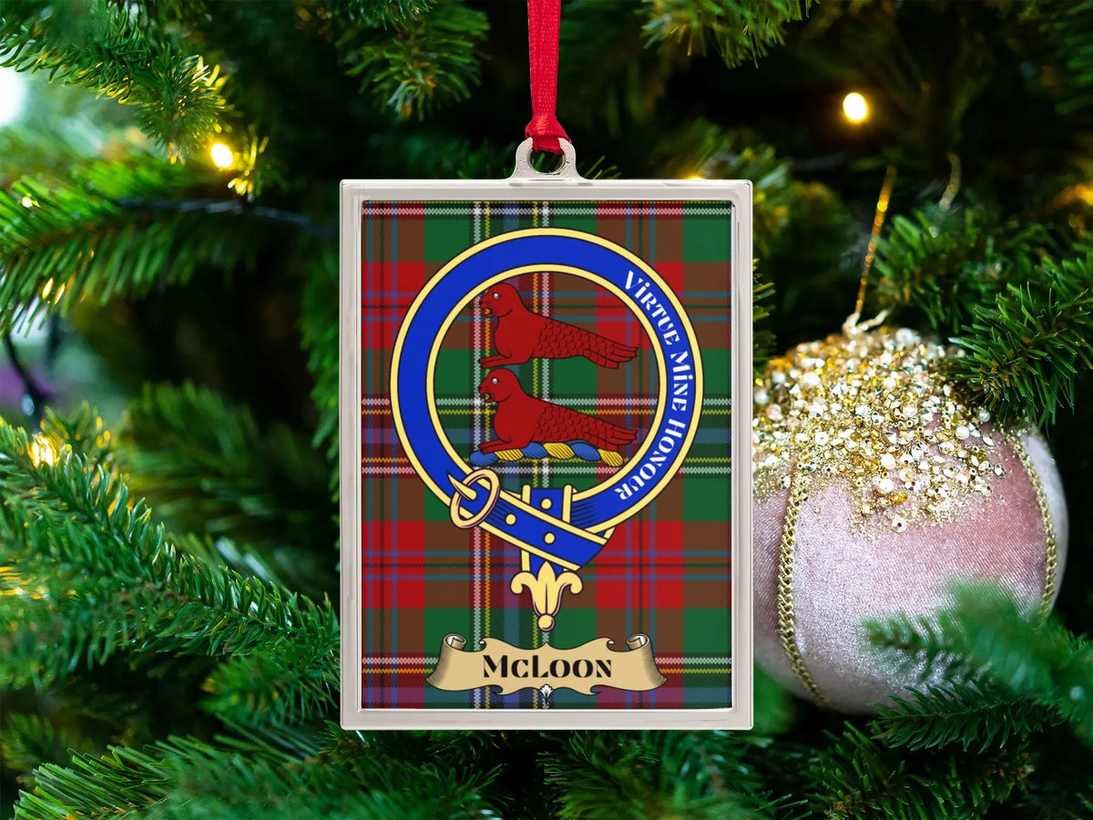 McLoon clan crest Christmas ornament in a silver frame on a tartan background