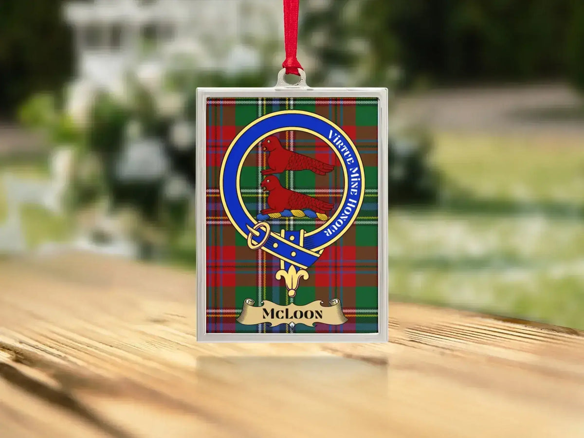 Close-up of the McLoon family crest on a polished silver-frame metal ornament