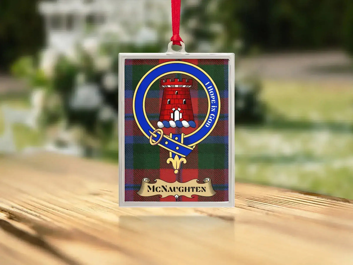 Close-up of the McNaughten family crest on a polished silver-frame metal ornament