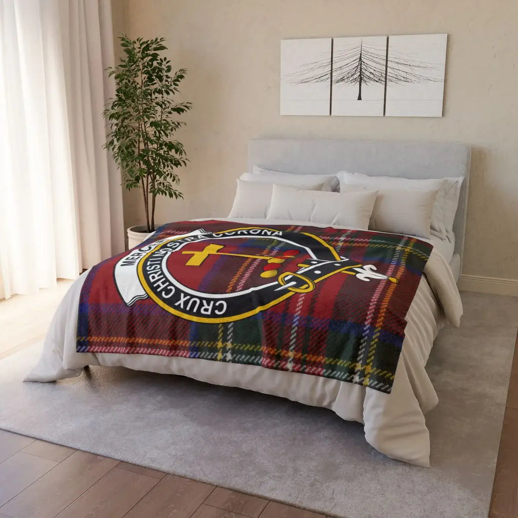 Mercer clan crest throw on sofa — printed tartan design with cross and shield emblem, white reverse